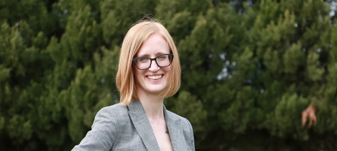 woman in a grey blazer smiling