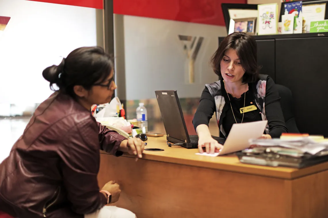 YMCA staff helping with financial assistance application