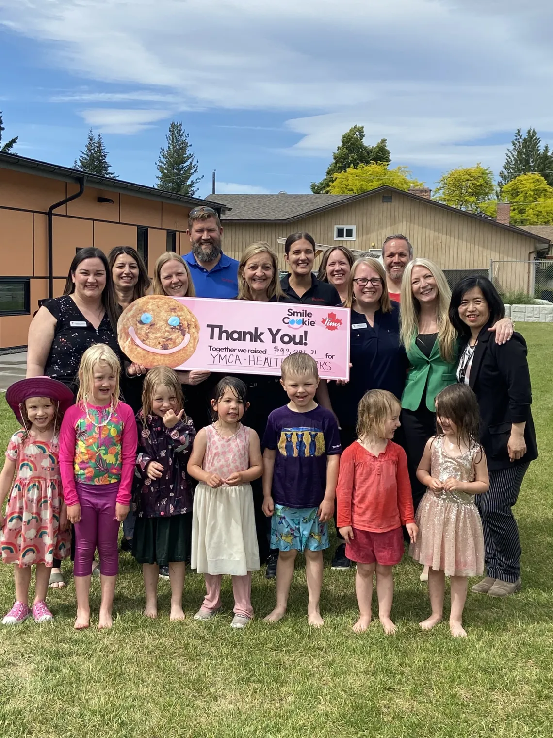 Travis with staff and children in child care outdoor space