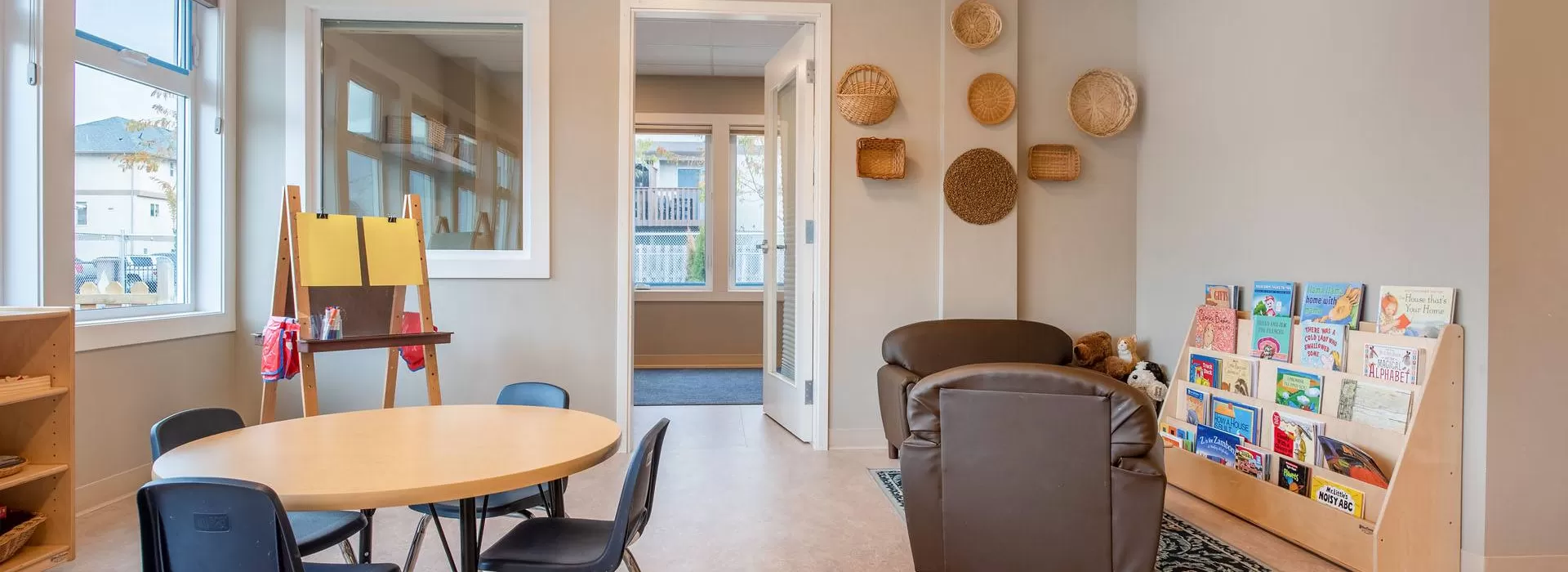 Queen's Park Child Care Interior: chairs books and art easel