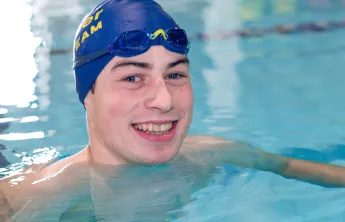 Zachary Bernier smiles up from Kelowna Family Y swimming lane