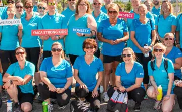 Team Interior Savings wearing blue and holding signs