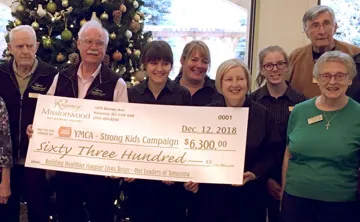 Missionwood Retirement Resort staff and seniors holdign a large check