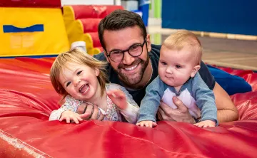 Paul smiling with his two young kids