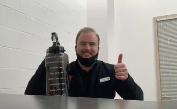 man holding up a water bottle