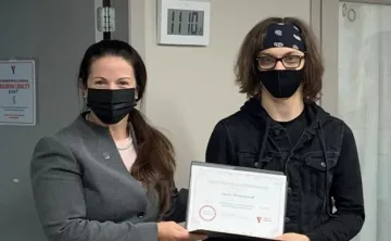 Two people holding up a certificate
