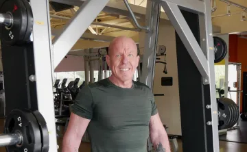 man in gym smiling