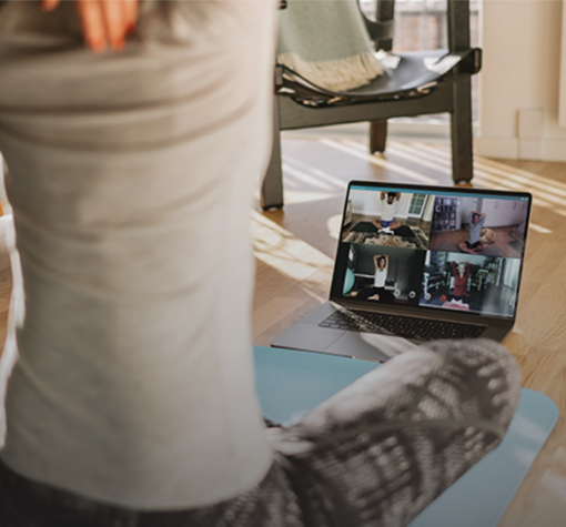 Y@Home+ doing yoga in front of a computer