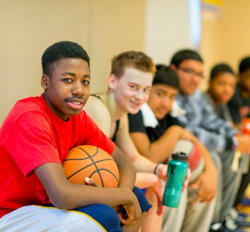 Recreation and Activities Young guys sitting on the basketball bench