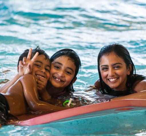 Swimming Three kids smiling in the pool