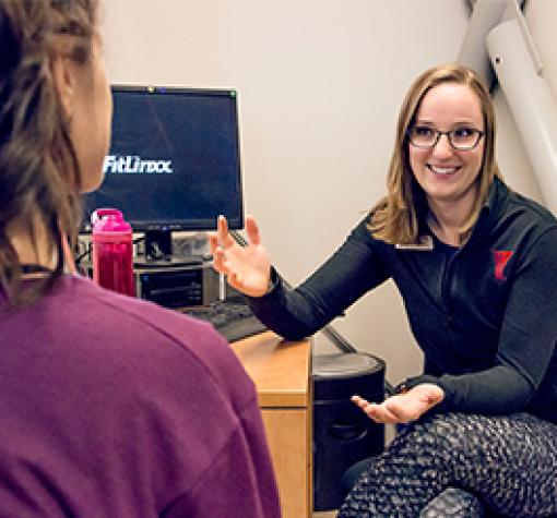 Health coaching Trainer speak with client at the health desk