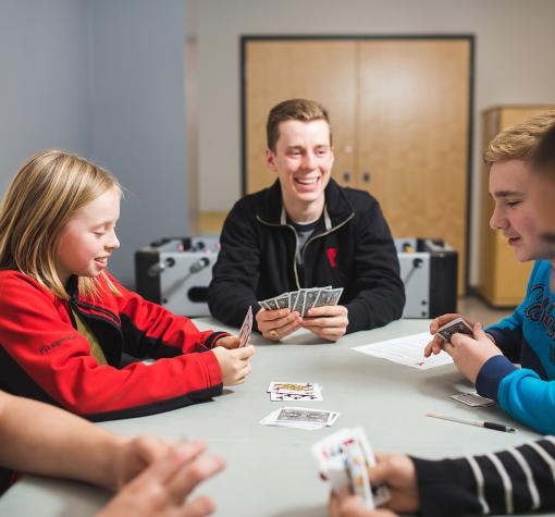 Teen after school program five teens playing cards