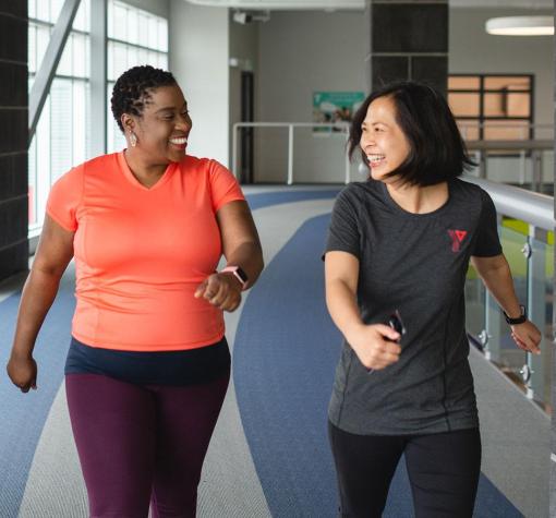 Orientation (teaser) YMCA staff member guides someone around walking track