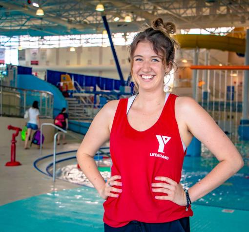Lifeguard Development Program smiling lifeguard with hands on hips by H2O waterpark