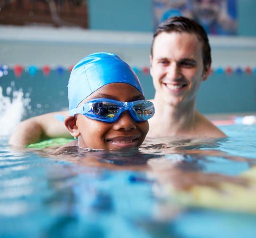 volunteer - safe for life young man helps child swim