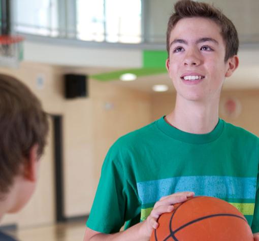 youth playing basketball in the gymnasium
