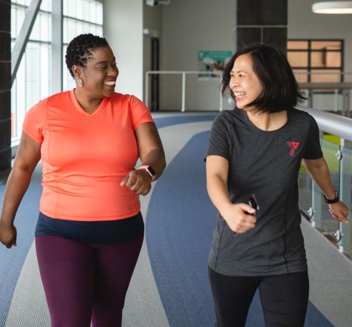 Coach and participant happily using walking track together