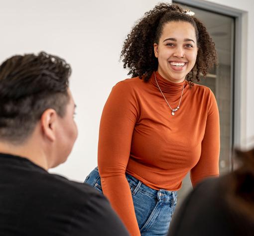 Woman smiling as she leads a meeting